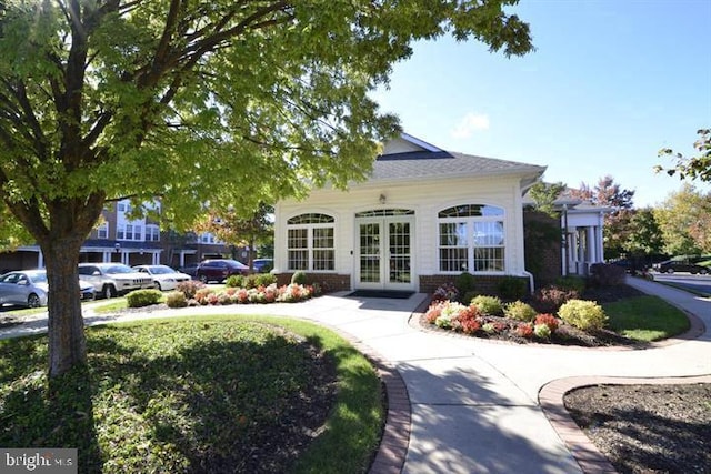 view of front of house featuring french doors and brick siding