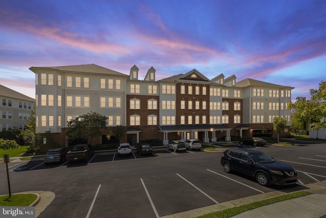 property at dusk with uncovered parking