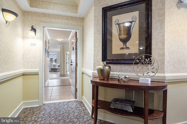 hall with wallpapered walls, carpet, and baseboards