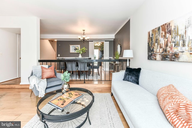 living area with an inviting chandelier and wood finished floors