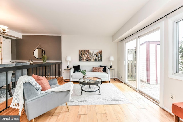 living area with baseboards and wood finished floors