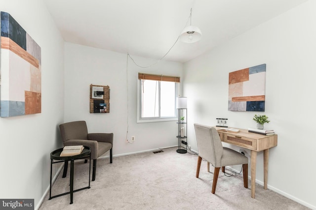 carpeted home office featuring baseboards