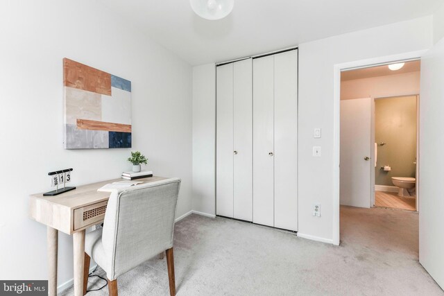 office featuring light carpet and baseboards