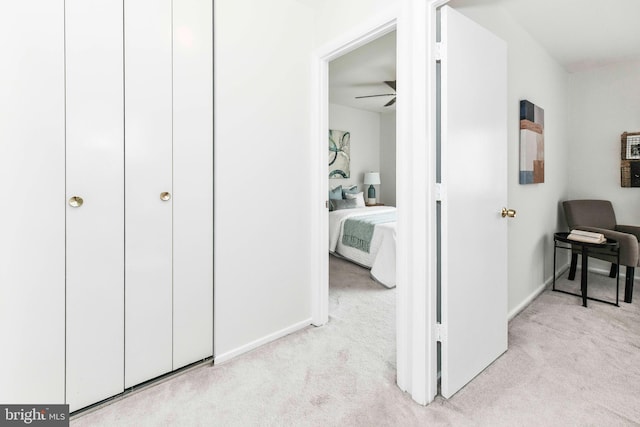 corridor with baseboards and carpet floors