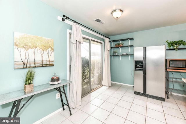 kitchen featuring open shelves, light tile patterned floors, visible vents, and appliances with stainless steel finishes