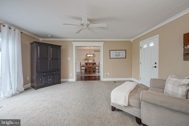 living room with ceiling fan, crown molding, baseboards, and light carpet