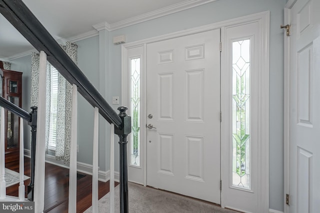 entryway featuring stairs, wood finished floors, baseboards, and ornamental molding