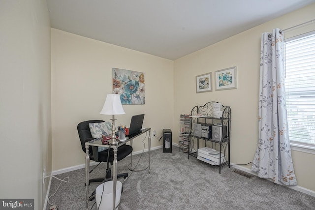 office space with visible vents, carpet flooring, and baseboards