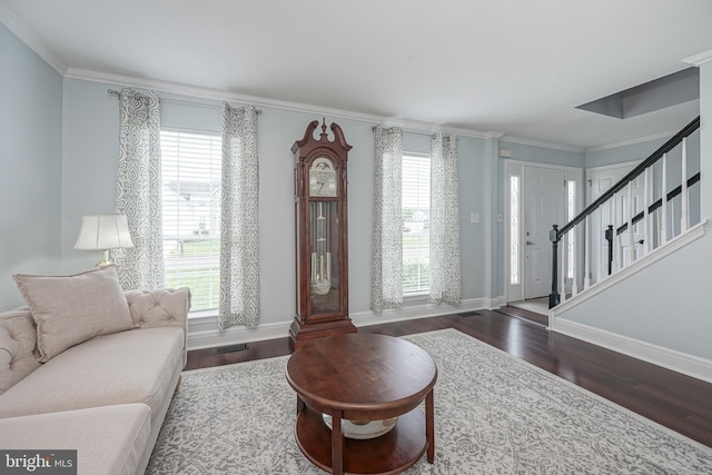 living area featuring a wealth of natural light, wood finished floors, and stairs