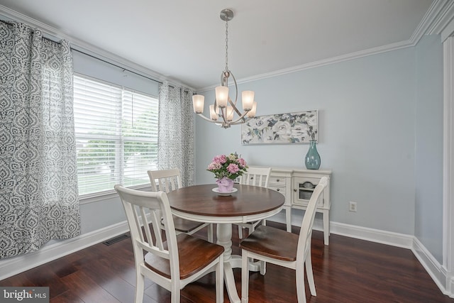 dining area featuring visible vents, baseboards, wood finished floors, and crown molding