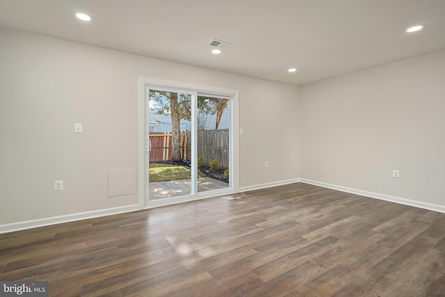 spare room featuring recessed lighting, visible vents, baseboards, and dark wood-type flooring