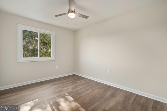 spare room with a ceiling fan, baseboards, and wood finished floors