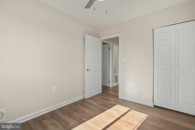 unfurnished bedroom with visible vents, ceiling fan, baseboards, and wood finished floors