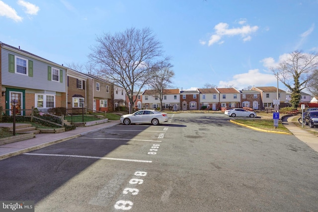 view of road featuring sidewalks, curbs, and a residential view