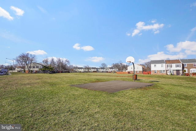 view of yard featuring a residential view and community basketball court