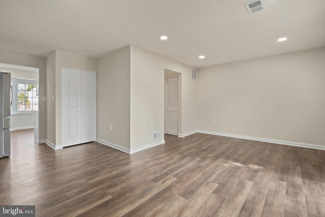 unfurnished bedroom with recessed lighting, dark wood-style floors, and visible vents