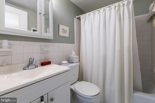 bathroom featuring vanity, tile walls, toilet, and shower / bathtub combination with curtain