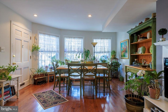 dining area with a fireplace, recessed lighting, and wood finished floors