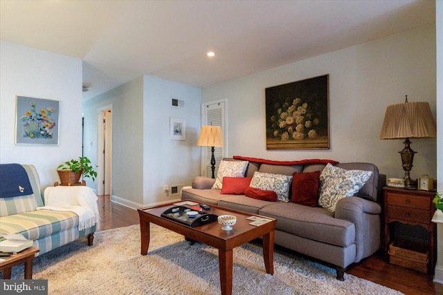 living room with recessed lighting, wood finished floors, visible vents, and baseboards