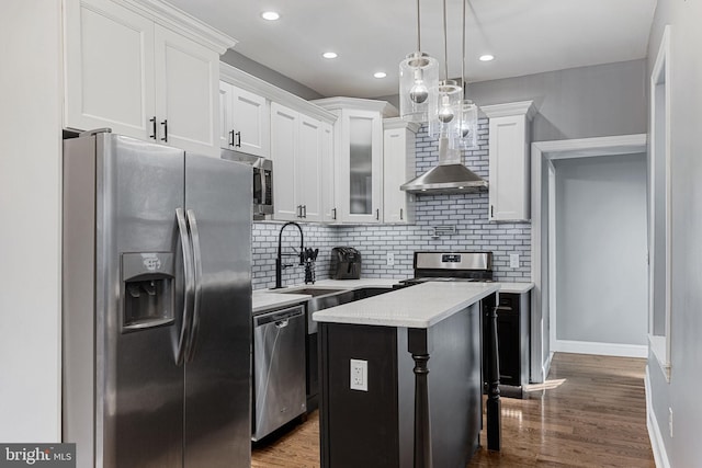 kitchen featuring backsplash, dark wood-type flooring, a kitchen island, and appliances with stainless steel finishes