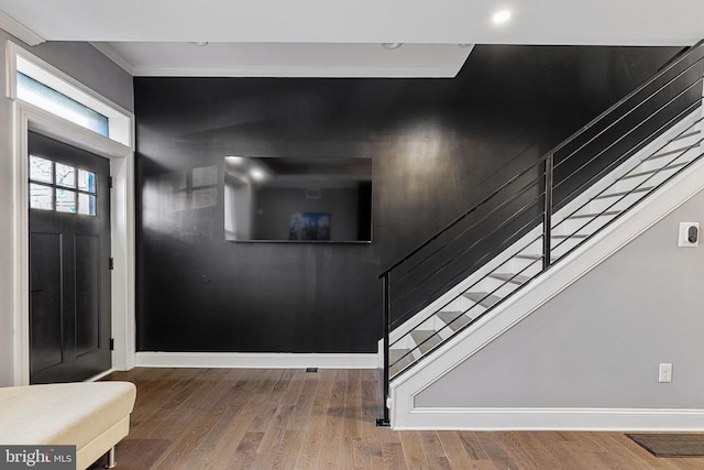 foyer featuring stairway, baseboards, and wood finished floors