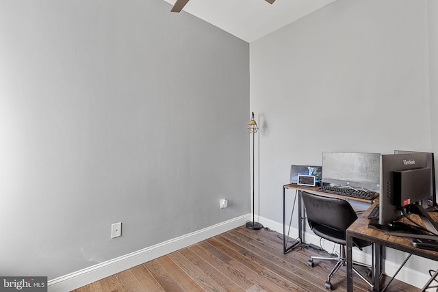 office area with baseboards, wood finished floors, and a ceiling fan