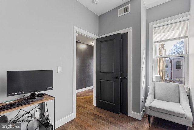 interior space featuring visible vents, baseboards, and wood finished floors