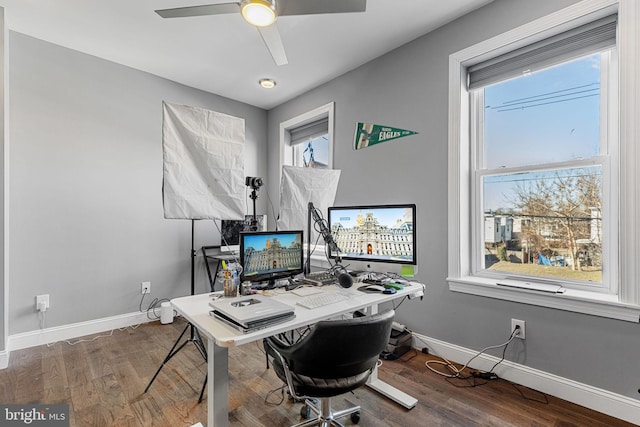 office space featuring a wealth of natural light, baseboards, and wood finished floors