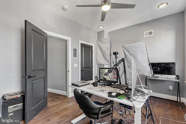 office area with visible vents, ceiling fan, baseboards, and wood finished floors