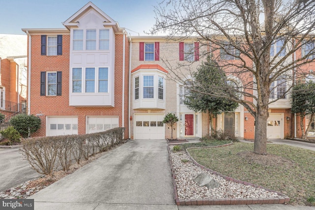 view of property featuring brick siding, concrete driveway, and an attached garage