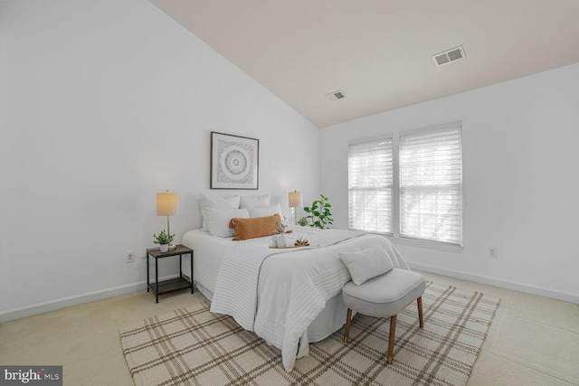 carpeted bedroom with visible vents, baseboards, and vaulted ceiling