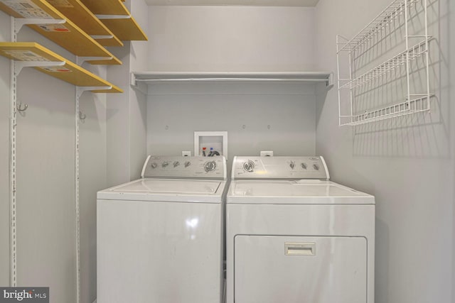 clothes washing area featuring laundry area and washer and clothes dryer