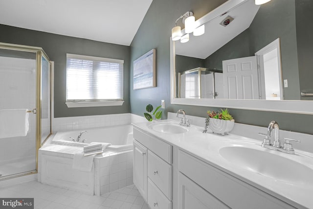 full bath with lofted ceiling, a shower stall, and a sink