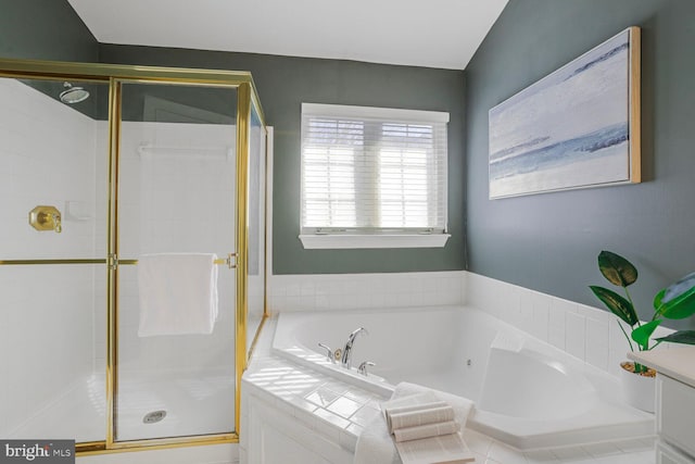 bathroom featuring a bath and a shower stall