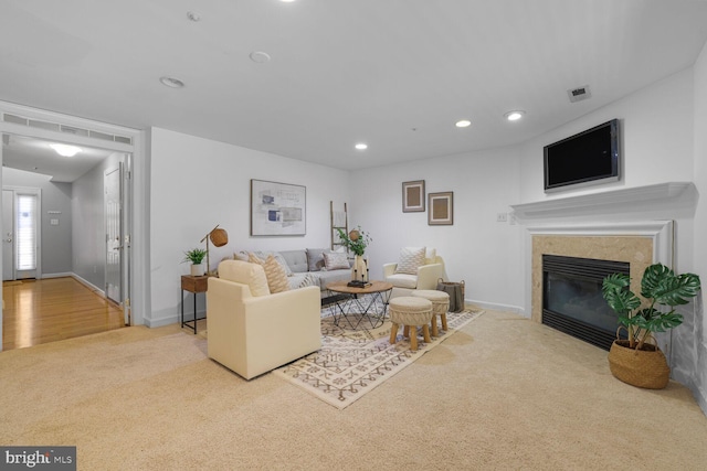 living area featuring visible vents, recessed lighting, carpet flooring, a fireplace, and baseboards