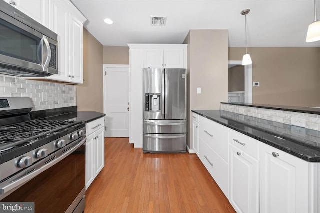 kitchen with visible vents, light wood finished floors, appliances with stainless steel finishes, and white cabinetry