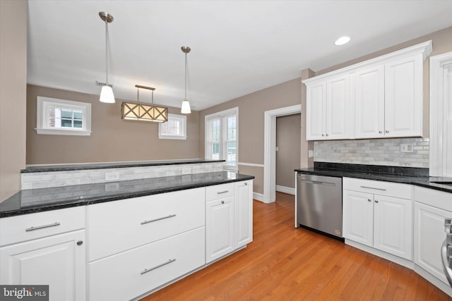 kitchen featuring white cabinetry, light wood-style floors, stainless steel dishwasher, decorative light fixtures, and backsplash