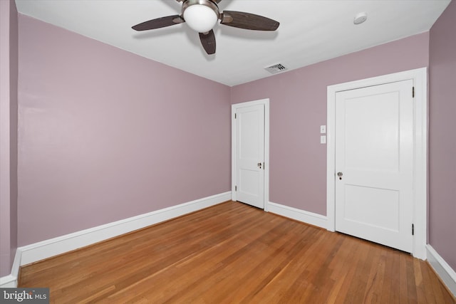 unfurnished bedroom with visible vents, baseboards, light wood-style floors, and ceiling fan