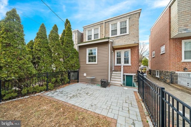 rear view of property with fence private yard and a patio area