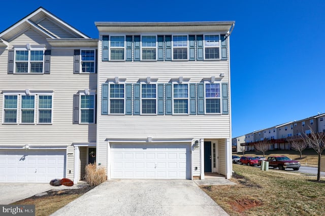 multi unit property featuring an attached garage and driveway