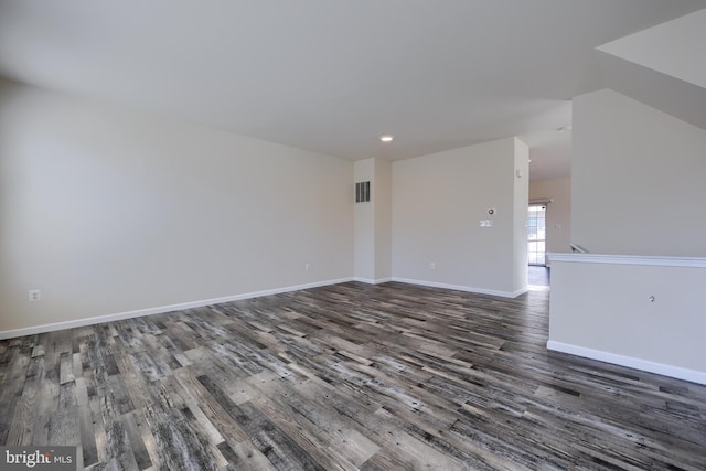 unfurnished room with wood finished floors, baseboards, and visible vents