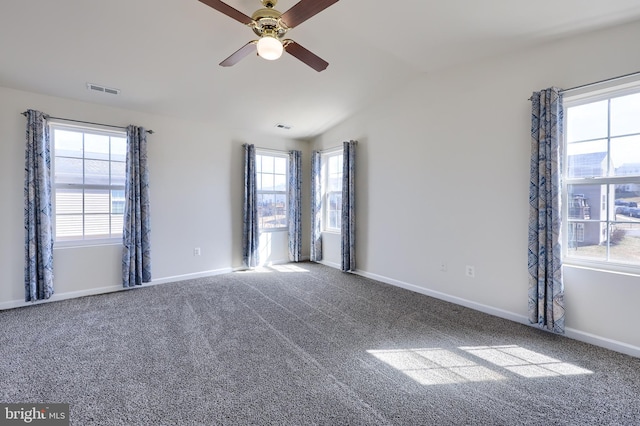 carpeted spare room featuring visible vents, ceiling fan, baseboards, and lofted ceiling