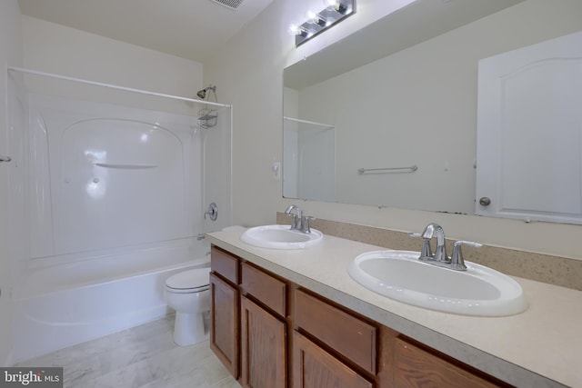 full bath with a sink, shower / tub combination, double vanity, and toilet