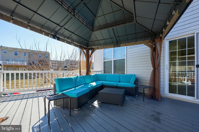 wooden terrace with a gazebo and an outdoor hangout area