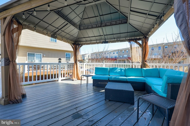 wooden deck with a gazebo and an outdoor hangout area