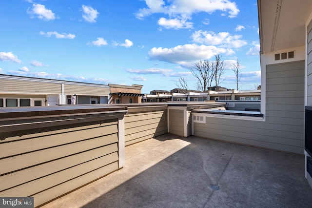 view of patio featuring a balcony and visible vents