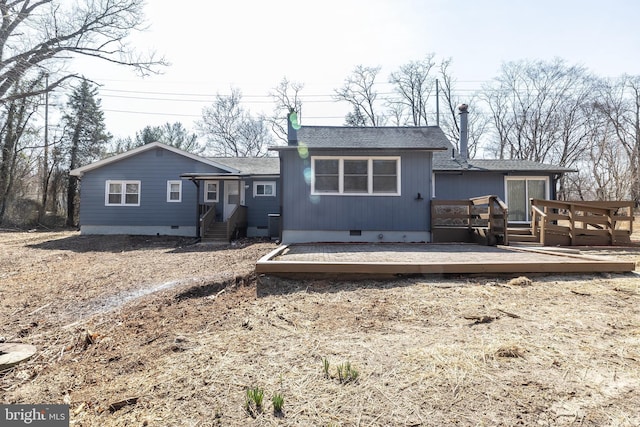 back of property featuring crawl space, a wooden deck, and a shingled roof