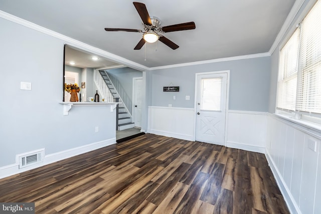 entryway featuring visible vents, a wainscoted wall, a ceiling fan, wood finished floors, and stairway