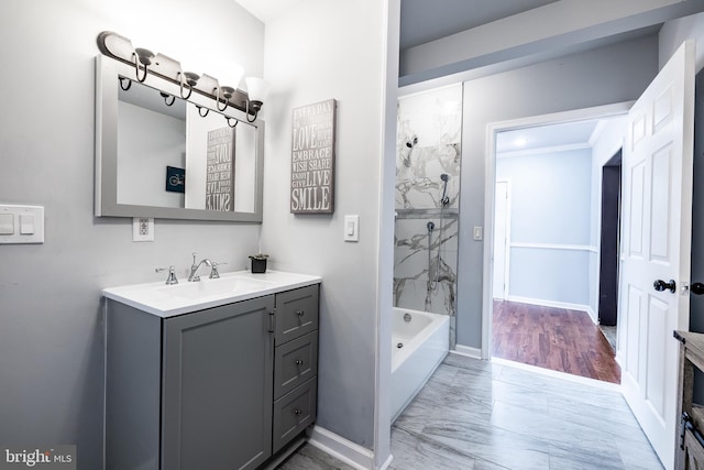 bathroom with vanity, baseboards, marble finish floor, and shower / bath combination