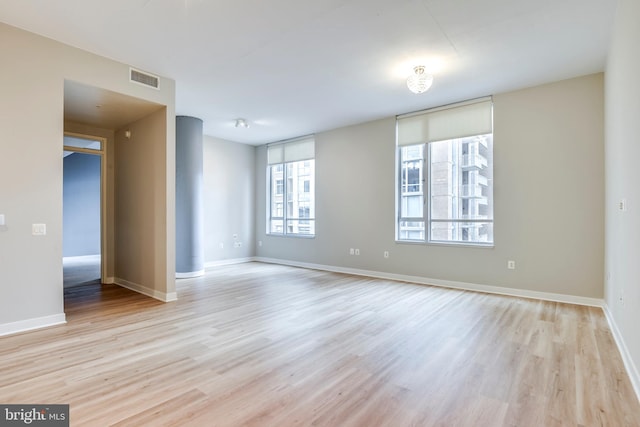 unfurnished room featuring visible vents, baseboards, and light wood-style flooring